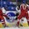 PLYMOUTH, MICHIGAN - MARCH 31: Switzerland's Alina Muller #25 protects the puck along the boards from Czech Republic's Lucie Povova #13 (right) and Petra Herzigova #6 (left) during preliminary round action at the 2017 IIHF Ice Hockey Women's World Championship. (Photo by Minas Panagiotakis/HHOF-IIHF Images)

